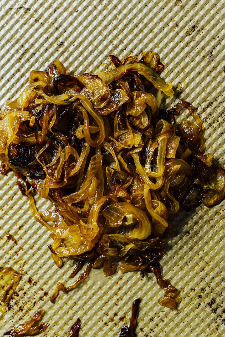 Deeply caramelized onions in a skillet, showing the dark amber-brown color from slow cooking