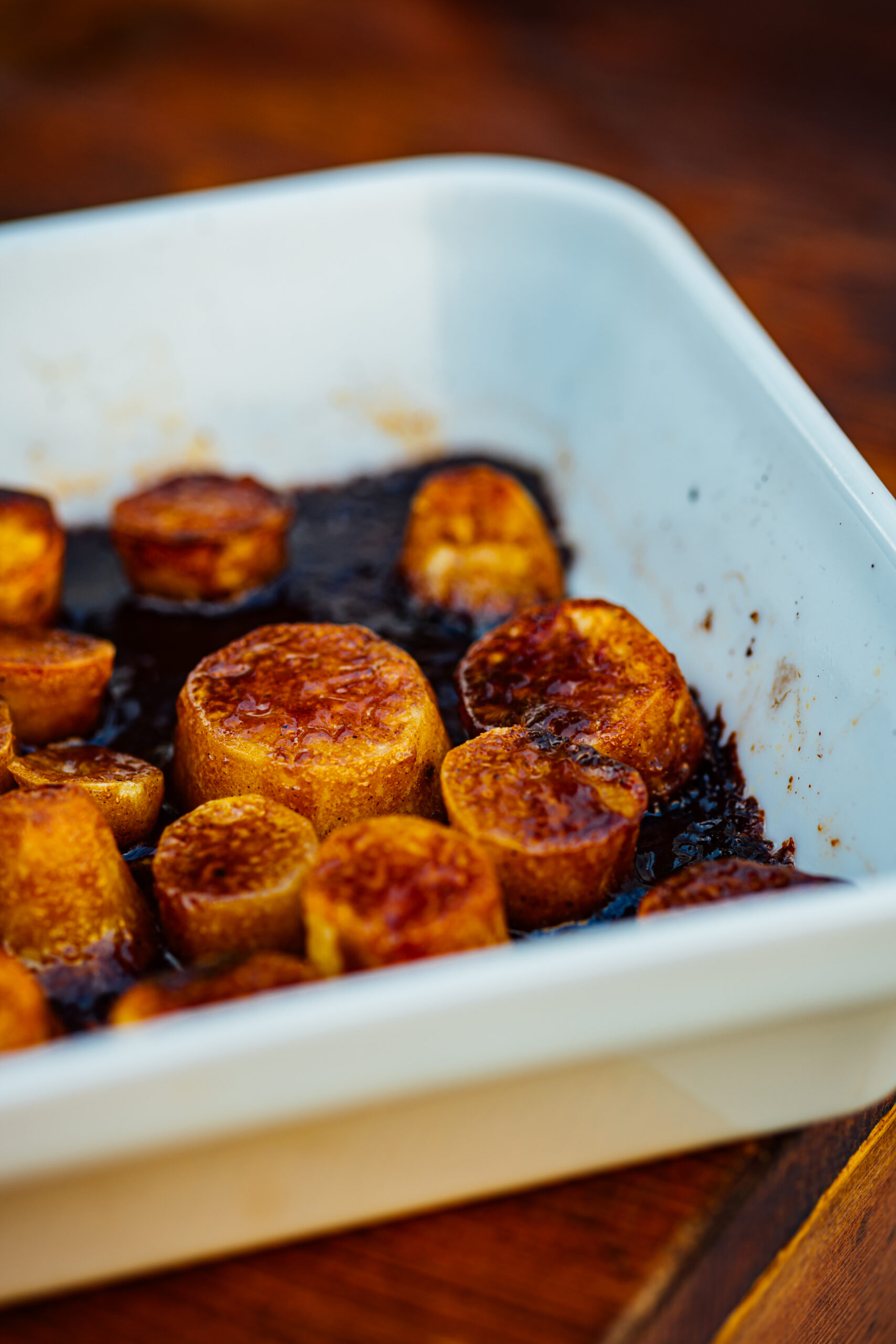 Chai-spiced candied sweet potatoes glazed with jaggery and topped with warm holiday spices.