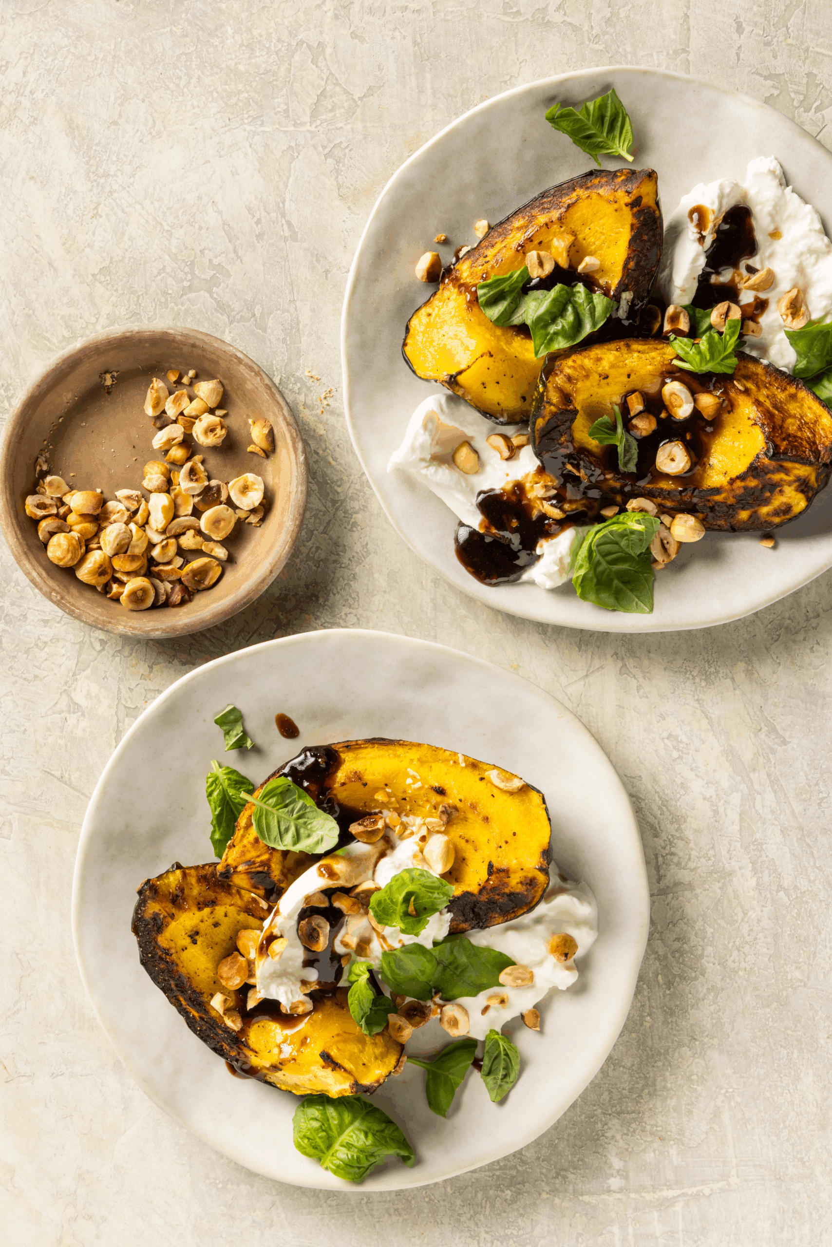 A stunning fall recipe: caramelized squash, balsamic agrodolce, burrata, and crunchy hazelnuts. Perfect for Thanksgiving or holiday entertaining.