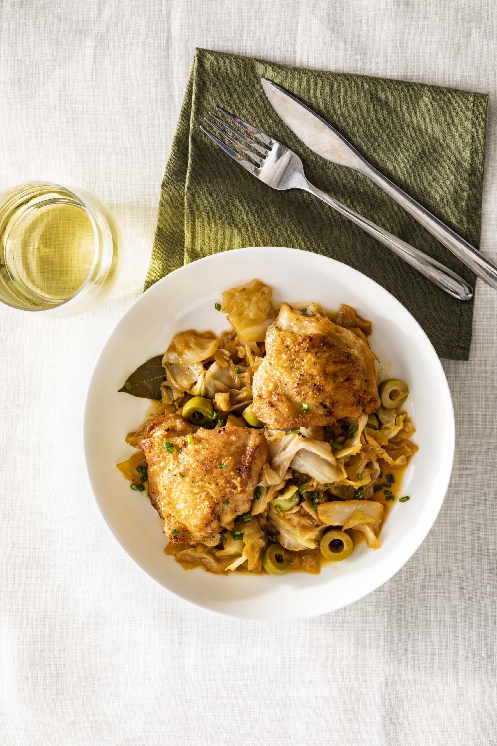 Braised chicken with cabbage and green olives in a Dutch oven